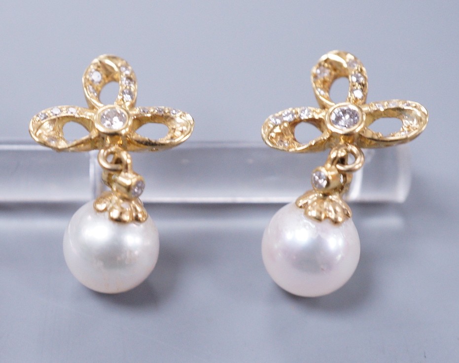 A modern pair of 18k yellow metal, cultured pearl and diamond cluster set drop earrings, 21mm, gross weight 4.3 grams.